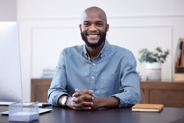 happy-desk-portrait-black-man-entrepreneur-corporate-company-agency-office-arms-crossed-professional-african-young-person-employee-ready-business-development-with-smile_590464-183502-1.avif